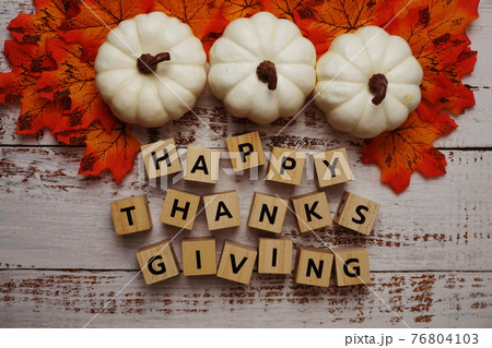 Happy Thanksgiving alphabet letter with pumpkins and autumn leaves on wooden background 76804103