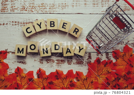 Cyber Monday alphabet letter and autumn leaves on wooden background Cyber Monday alphabet letter and autumn leaves on wooden background 76804321