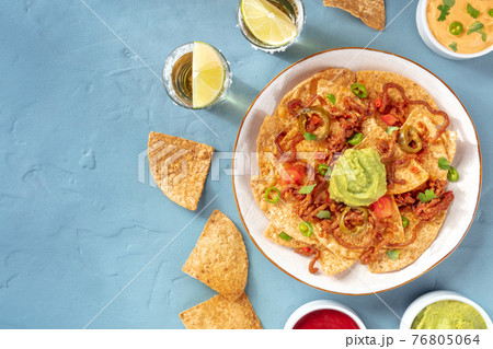 Nachos plate with tequila shots and a place for text Nachos plate with tequila shots and a place for text 76805064
