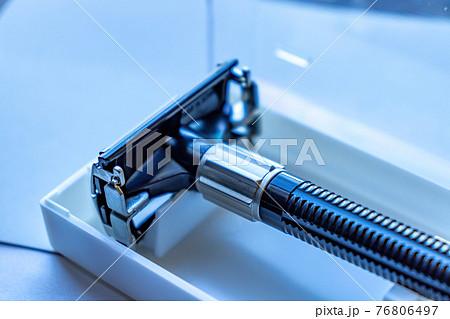 Closeup of the shaft of a handheld razor in its plastic container. 76806497