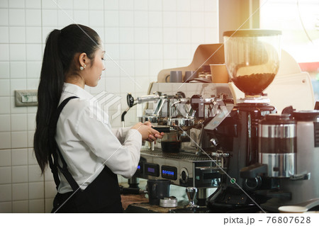 asian young women barista wear apron professional making espresso. 76807628