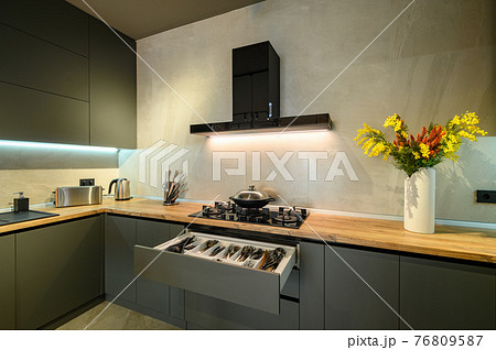 Modern large luxury dark gray kitchen with pulled out drawer Modern large luxury dark gray kitchen with pulled out drawer 76809587