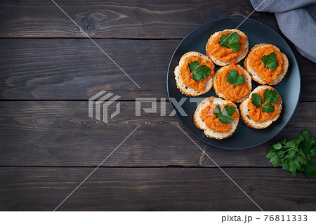 Sandwiches with bread zucchini caviar tomatoes onions. Homemade vegetarian food. Canned stewed vegetable. wooden background top view, copy space Sandwiches with bread zucchini caviar tomatoes onions. Homemade vegetarian food. Canned stewed vegetable. wooden background top view, copy space 76811333
