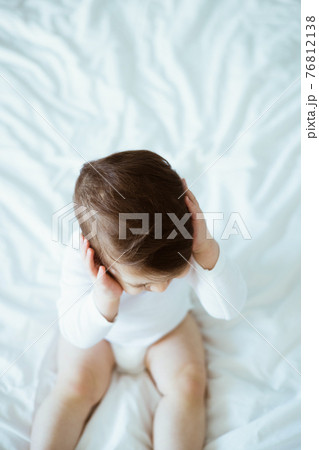 Little boy with ear pain moaning holding hand on ear at home, child headache pain, health care concept, ear protection , teeth pain Little boy with ear pain moaning holding hand on ear at home, child headache pain, health care concept, ear protection , teeth pain 76812138