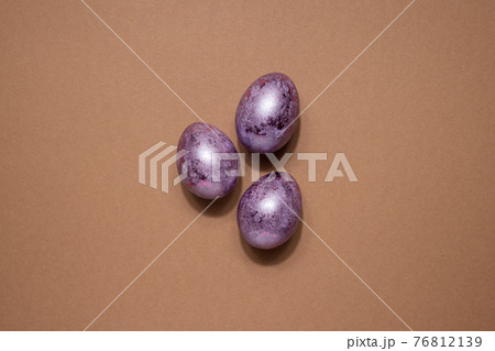 Glitter Easter eggs in pink purple colors on beige background. Easter holiday creative concept background with dark shadows 76812139