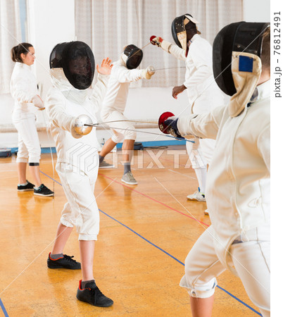 Young fencers training with coach 76812491