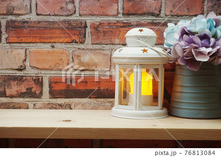 White lantern with LED Candle light on wooden shelve home decoration 76813084
