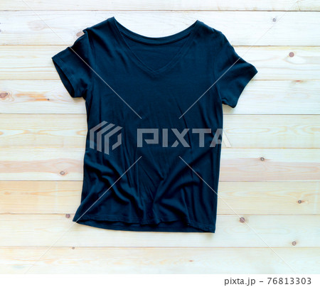 Black tshirt mockup on brown wooden background. Template, flat lay 76813303