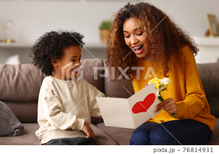 Young mixed race woman getting congratulations from son on Mothers day 76814931