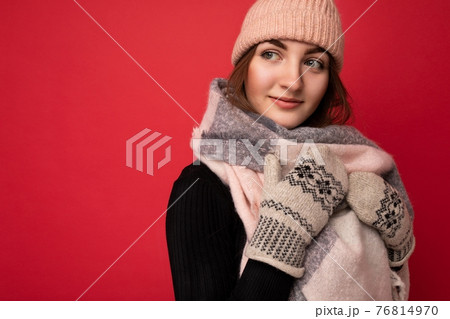 Closeup photo of beautiful happy cute young brunette woman isolated over red background wall wearing Closeup photo of beautiful happy cute young brunette woman isolated over red background wall wearing 76814970