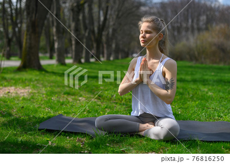Yoga practice and meditation outdoor. Girl in the park 76816250