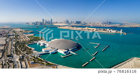 Louvre museum in Abu Dhabi emirate of the United Arab Emirates at sunrise aerial drone view of the building appear to float on the seaside 76816316