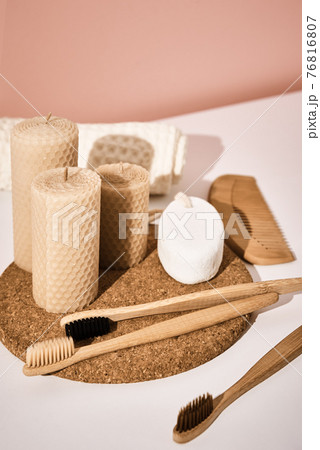 Bamboo toothbrushes with candles on pink background Bamboo toothbrushes with candles on pink background 76816807