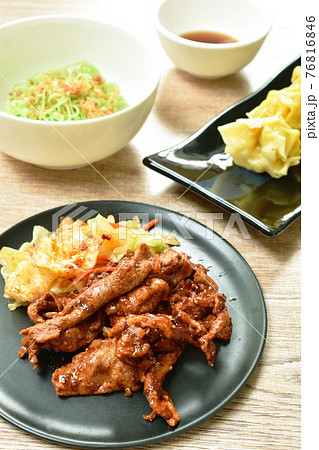 grilled slice pork dressing Sichuan pepper sauce and Chinese jade noodles dressing crispy fried chop garlic with steamed Chinese dumpling stuffed mashed pork on table 76816846