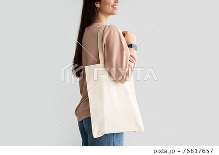 Young woman standing with blank canvas tote bag 76817657