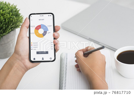 Unrecognizable woman counting spandings, using mobile app Unrecognizable woman counting spandings, using mobile app 76817710