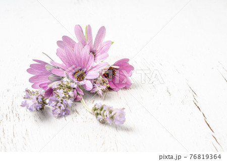 bunch of spring flowers on a wooden background with copy space 76819364