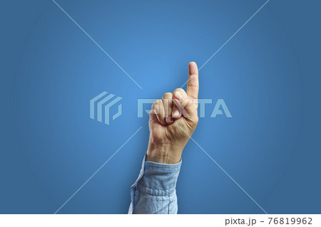 Man arm making pointing gesture with hand isolated on blue background 76819962