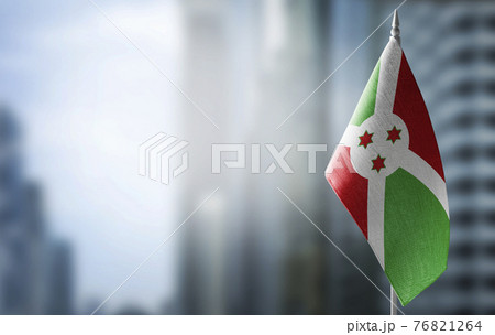 A small flag of Burundi on the background of a blurred background 76821264