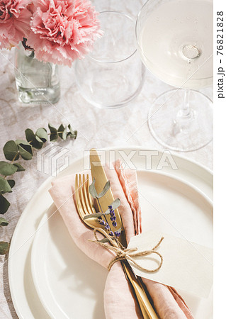Overhead view on table setting with golden cutlery. 76821828