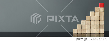 Red wooden cube is on top of other cubes 76824657