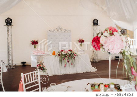 wedding table decoration with flowers on the table in the castle, table decor for dinner by candlelight.Dinner with candles 76824853