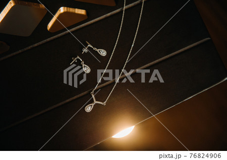 Accessories for the bride. Earrings and a chain with a pendant. White wedding earrings. 76824906