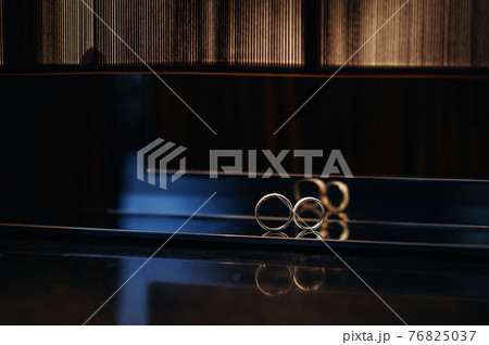 Close-up of two gold wedding rings for a wedding Close-up of two gold wedding rings for a wedding 76825037