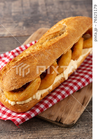 Calamari rings sandwich on wooden table, typical food from Madrid Calamari rings sandwich on wooden table, typical food from Madrid 76825179