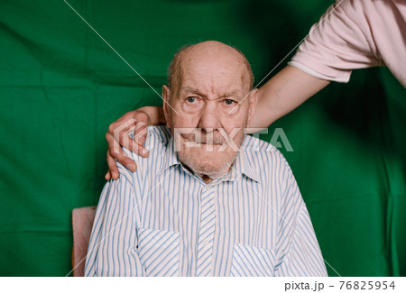 the young man hugs his old grandfather. caring for old people 76825954
