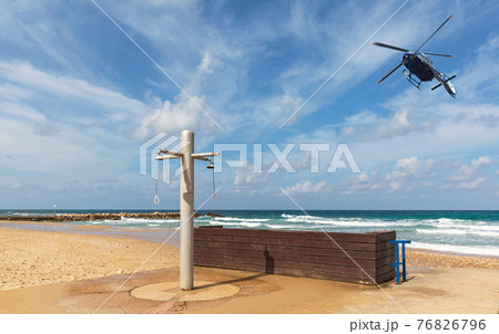 police helicopter flying over the beach 76826796