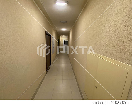 Corridor of new residential building under construction view. Aerated concrete blocks house corridor walls under construction ready for plastering, stucco. Long and narrow corridor with elevator door Corridor of new residential building under construction view. Aerated concrete blocks house corridor walls under construction ready for plastering, stucco. Long and narrow corridor with elevator door 76827859