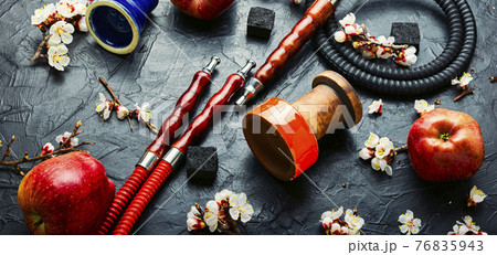 Smoking hookah or shisha with apple flavor Smoking hookah or shisha with apple flavor 76835943
