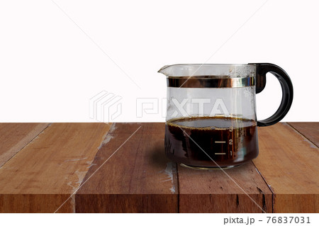 Coffee jar glass with cup and coffee maker on background. Coffee jar glass with cup and coffee maker on background. 76837031