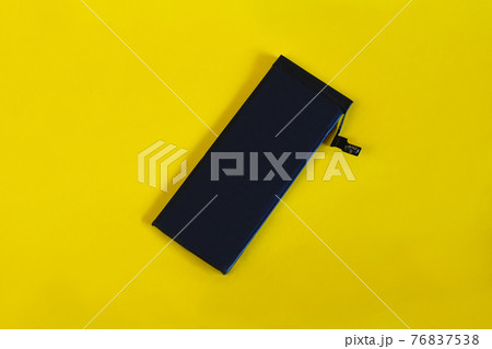 Swollen lithium ion polymer battery inside a mobile phone on background. Swollen lithium ion polymer battery inside a mobile phone on background. 76837538