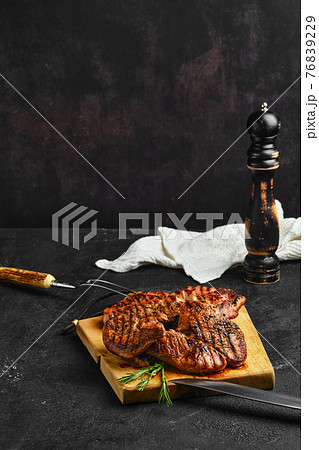 Juicy lamb steaks on wooden cutting board Juicy lamb steaks on wooden cutting board 76839229