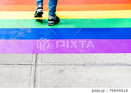 Feet Walking on Sidewalk Decorated with Rainbow Flag Feet Walking on Sidewalk Decorated with Rainbow Flag 76840819
