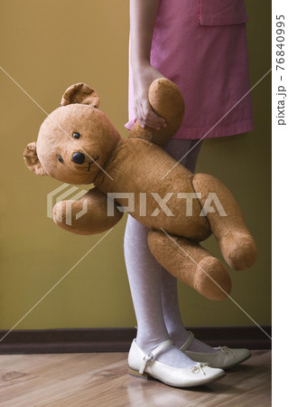 Lowsection Of Girl Holding Teddy Bear 76840995