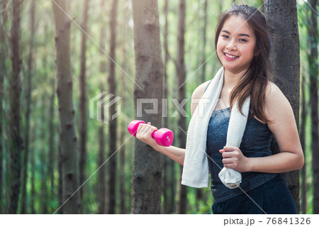 Beautiful sport young female woman lifestyle relaxation dumbbell workout 76841326