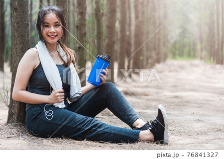 Beautiful sport young woman girl lifestyle exercise healthy break drinking water from bottle after running workout 76841327