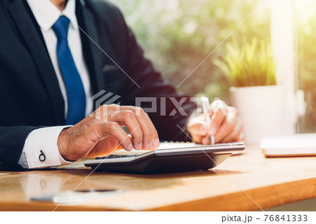 Business man accounting using calculating and work with laptop computer Business man accounting using calculating and work with laptop computer 76841333