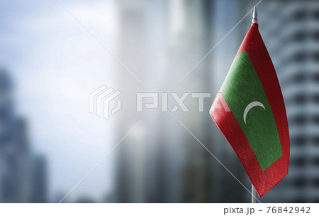 A small flag of Maldives on the background of a blurred background A small flag of Maldives on the background of a blurred background 76842942
