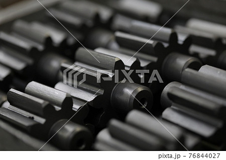 Lot of black metal parts lying on table closeup Lot of black metal parts lying on table closeup 76844027