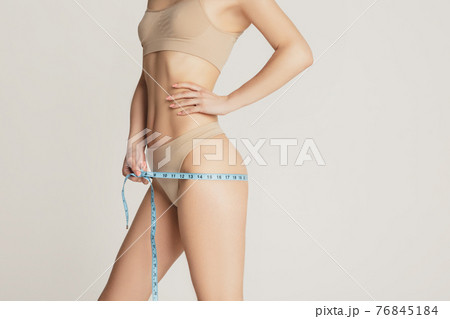 Beautiful female body in nude color underwear - Stock Photo