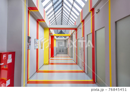 Long empty corridor in a modern industrial building 76845451