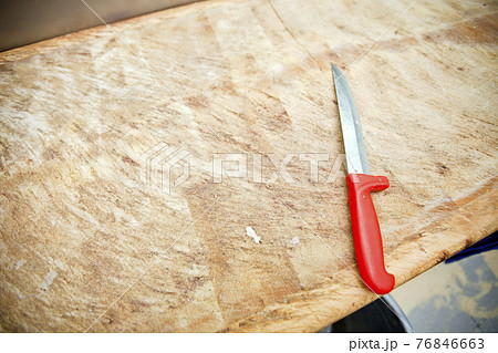 Kitchen knife on wooden cutting board in store Kitchen knife on wooden cutting board in store 76846663