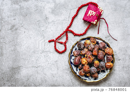 Popular food during Iftar - dry dates. Karan, rosary on concrete background Top view Flat lay Muslim holiday of holy month of Ramadan 76848001