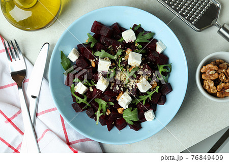 Concept of tasty eating with beet salad on white textured table 76849409