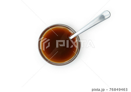 Bowl of caramel sauce with spoon isolated on white background Bowl of caramel sauce with spoon isolated on white background 76849463