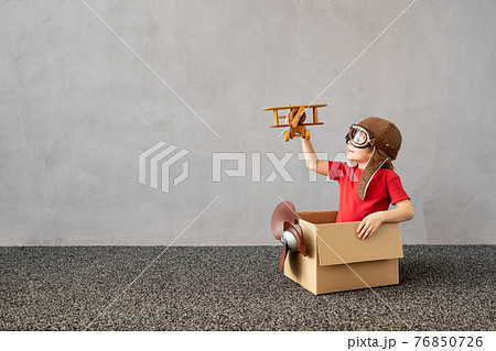 Happy child dreaming about travel 76850726